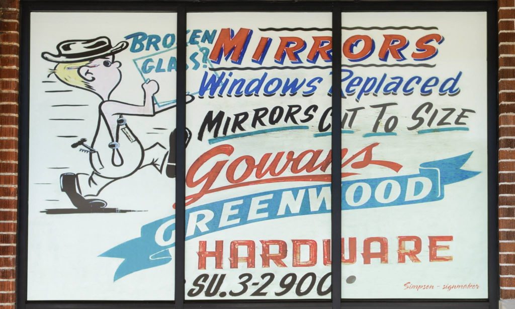 Vintage hand-painted Gowan's Greenwood Hardware window sign advertising mirrors and glass cut to size